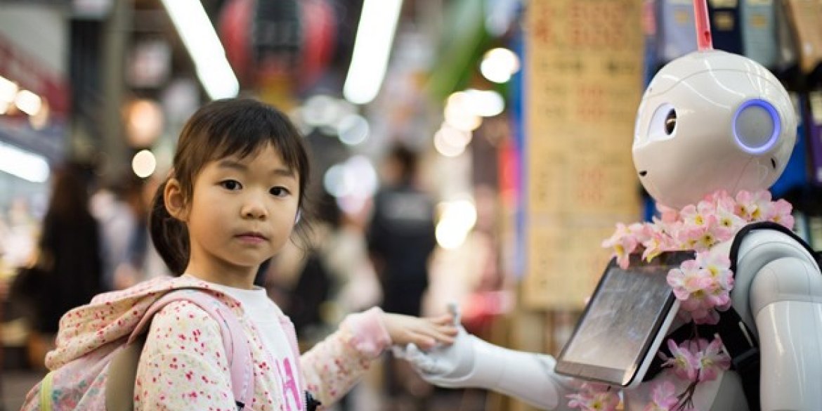young girl touching a robot