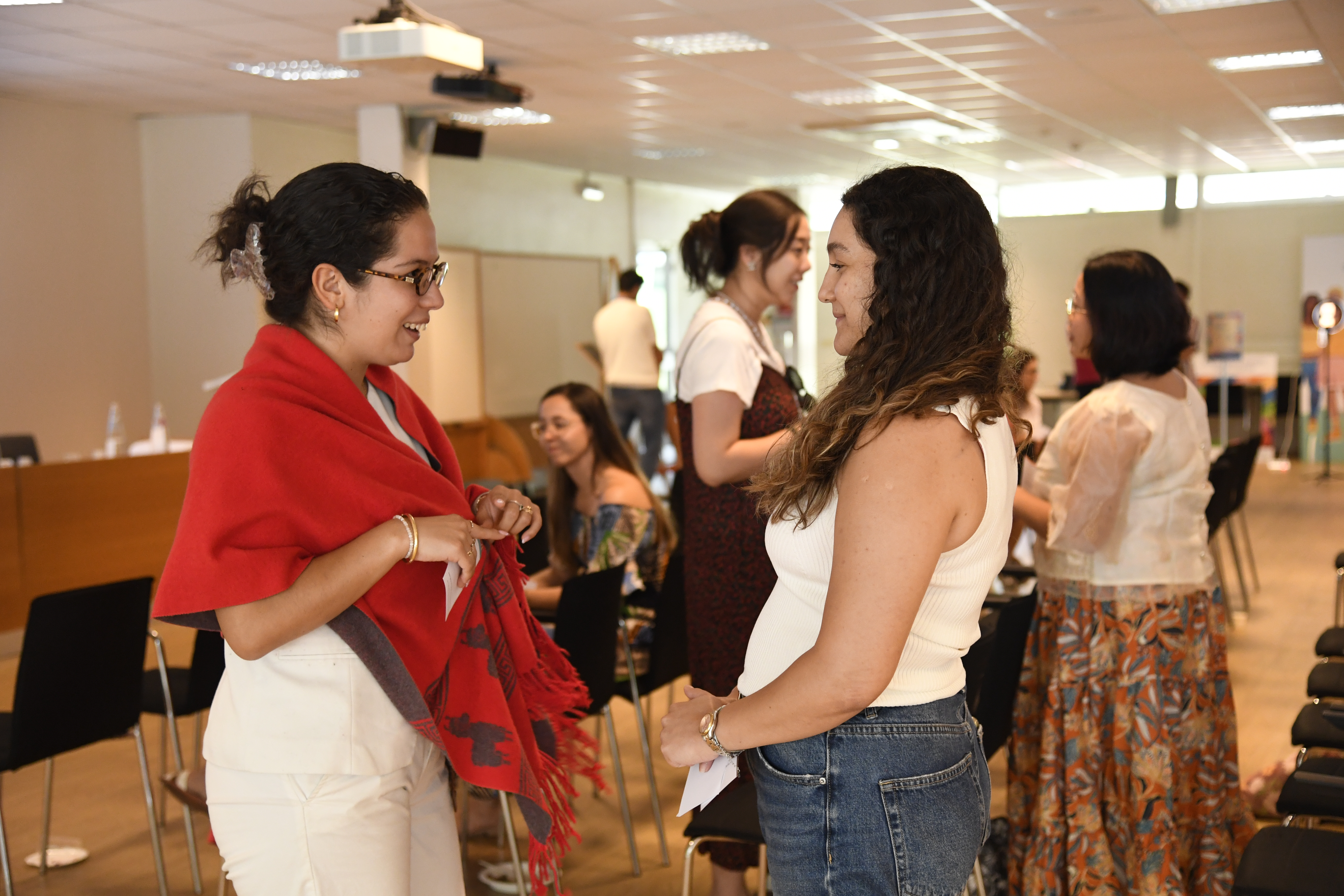Two women conversing as part of the mingle matrix activity
