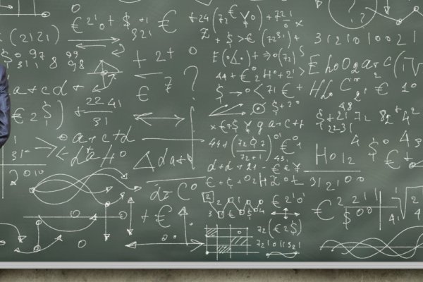 man looking at a chalkboard