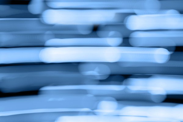 Abstract image with blurred horizontal streaks of blue and white light, creating a sense of motion and depth