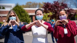 three people wearing covid masks