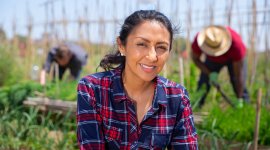 A smiling woman in a green field