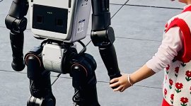 Robot holding hand child.