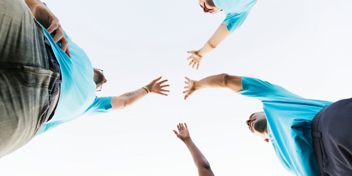 Four hands meeting in the center