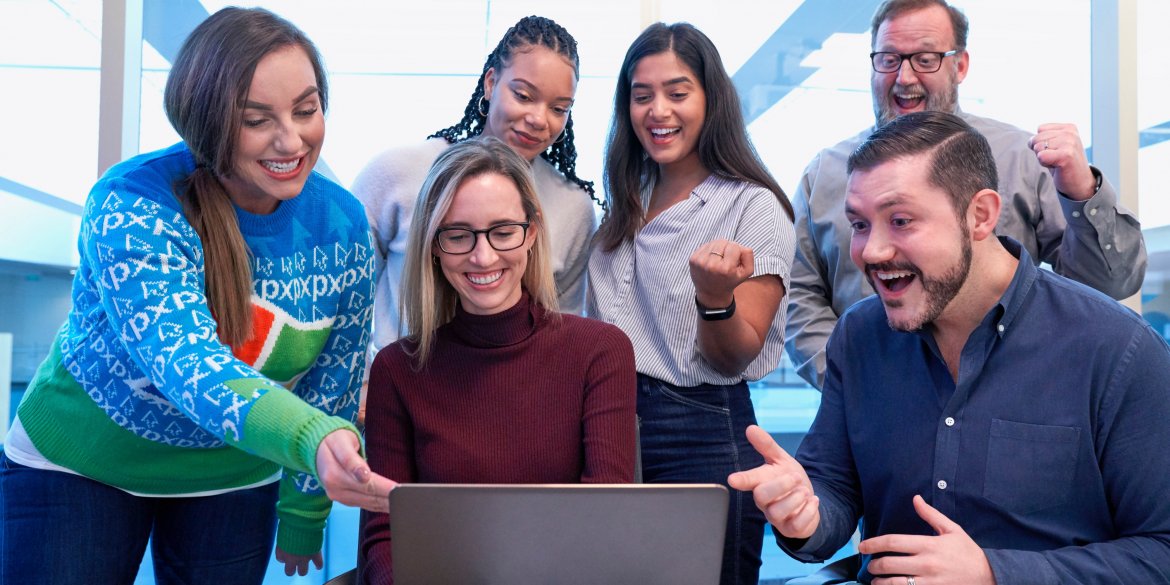 Digital credentials a group of happy people in front of a laptop