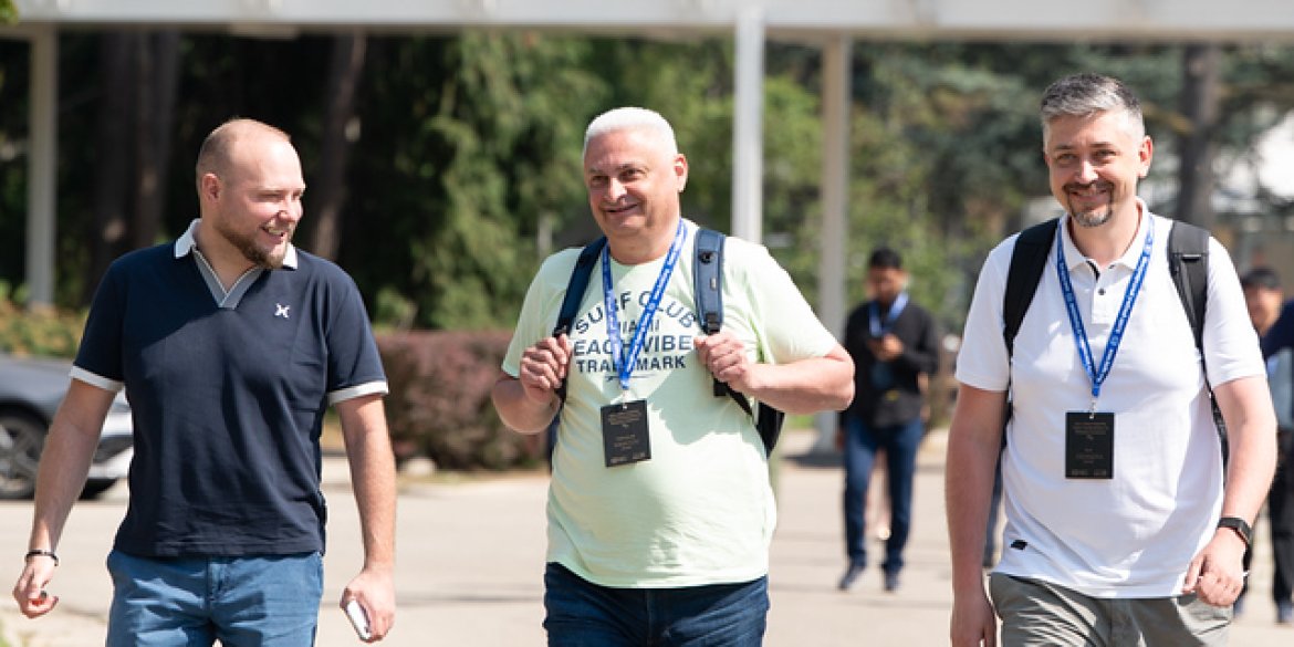 Three participants walking together outdoors.