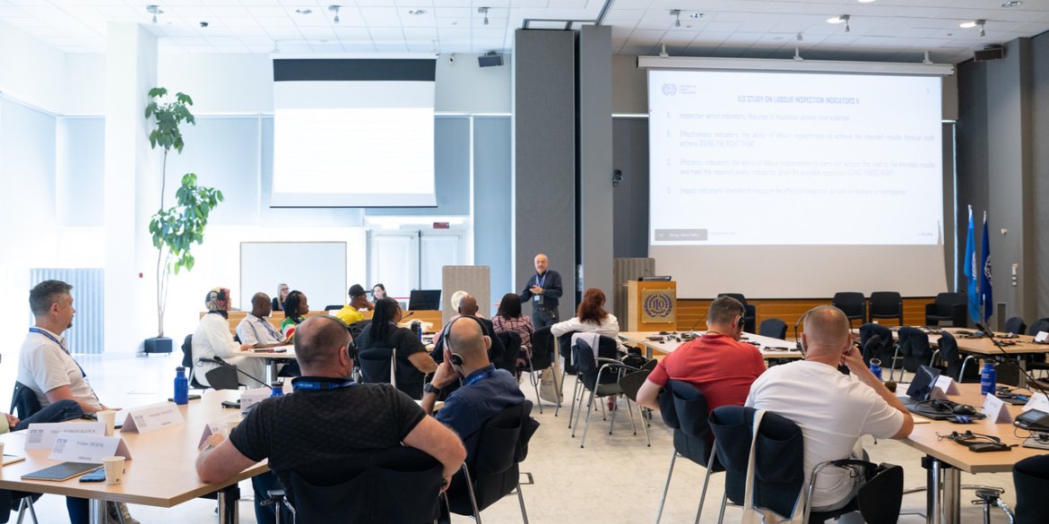 Participants attending a presentation in a conference room.