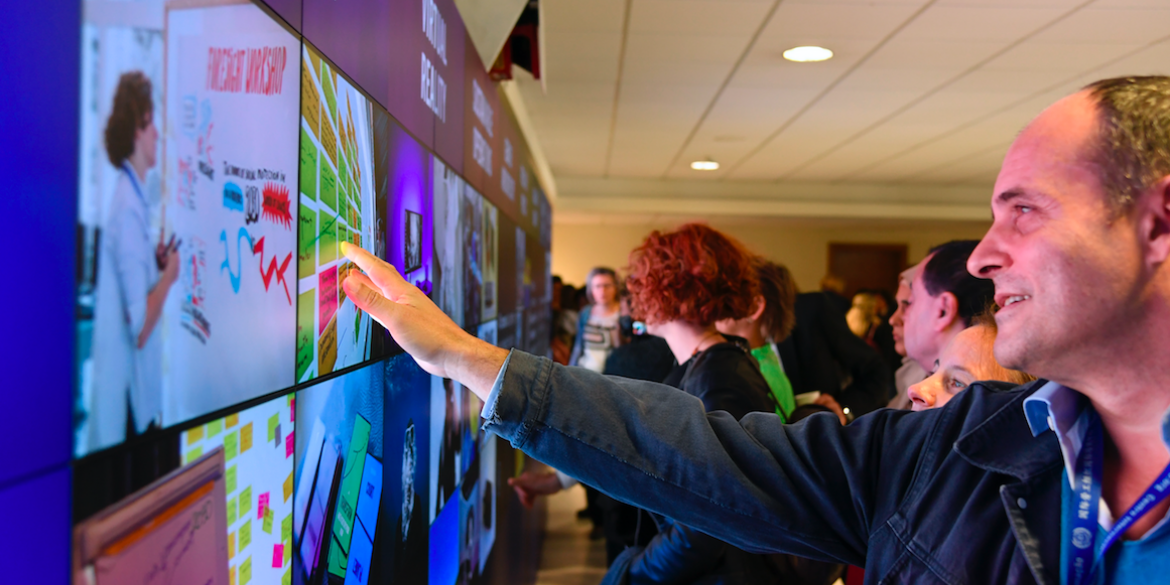 Man touching interactive video wall