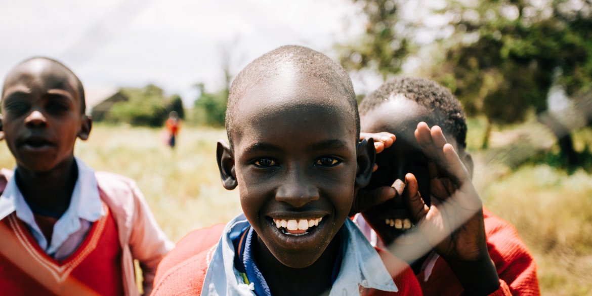 three boys smiling during daytime