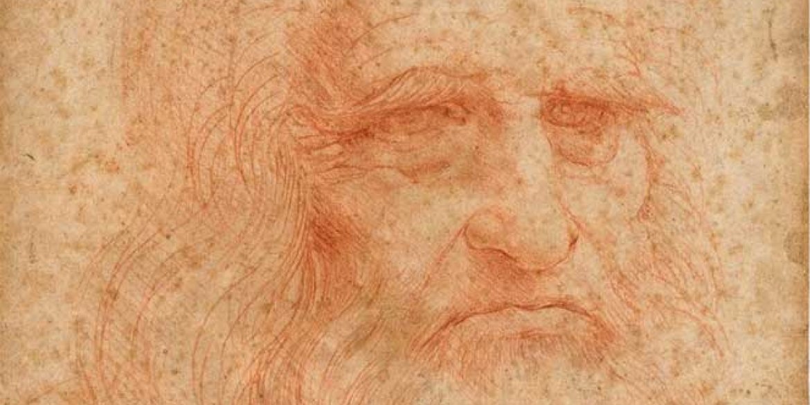 A detailed red chalk drawing of an elderly, bearded man's face, attributed to Leonardo da Vinci, featuring expressive eyes, a furrowed brow and flowing hair on aged parchment.