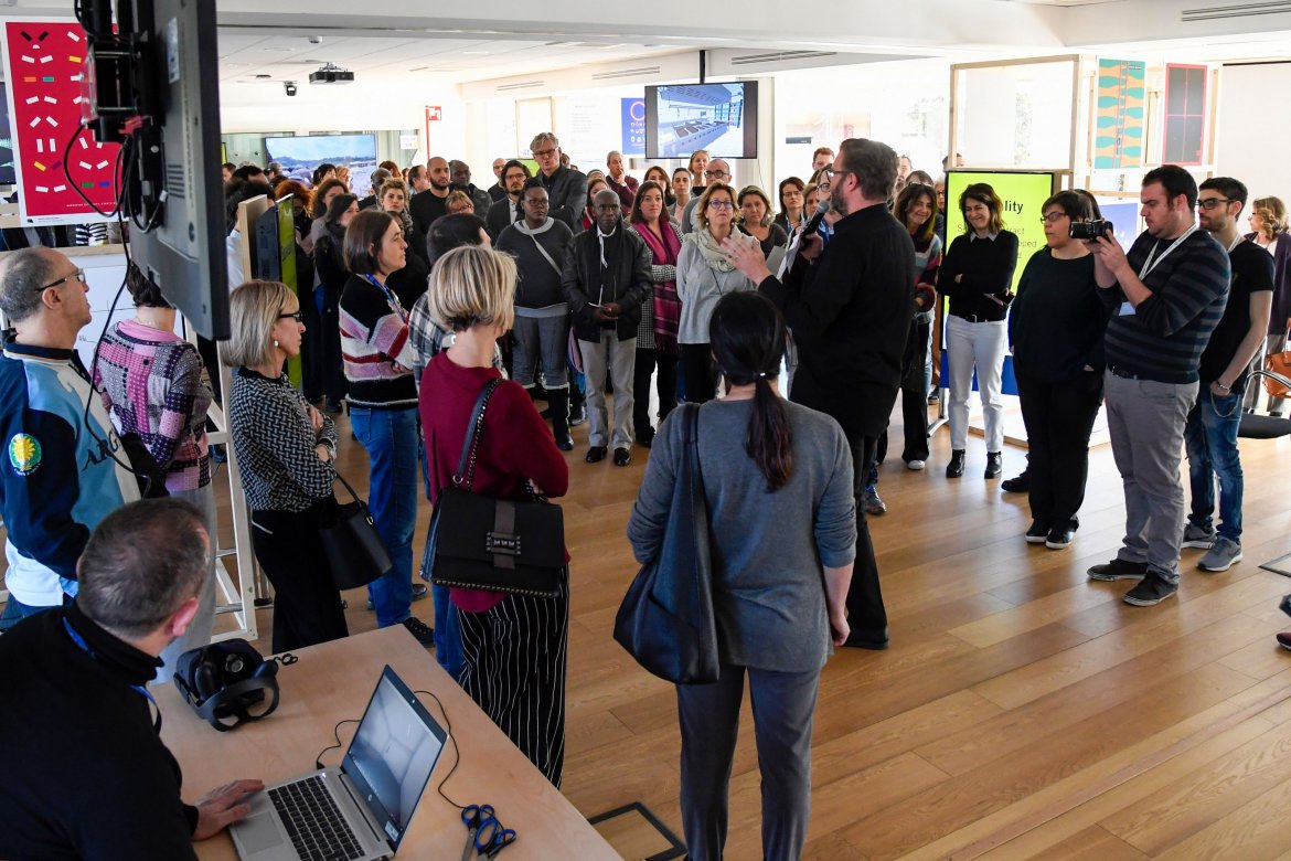 people gathered around a speaker