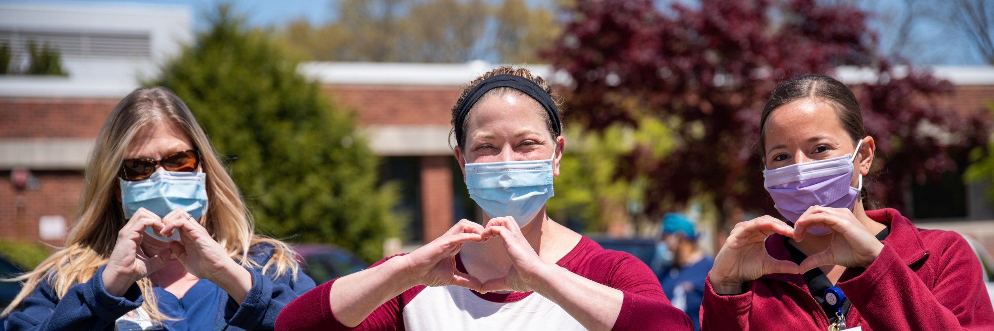 three people wearing covid masks