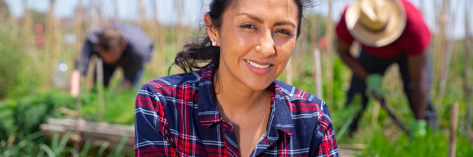 A smiling woman in a green field