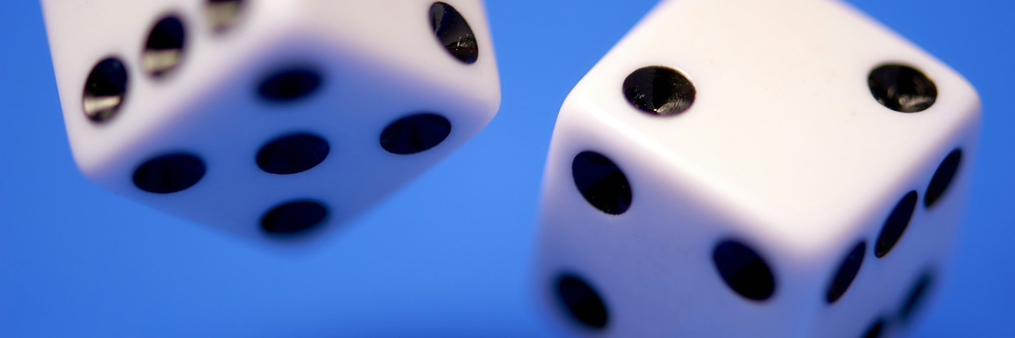 two white die on blue surface
