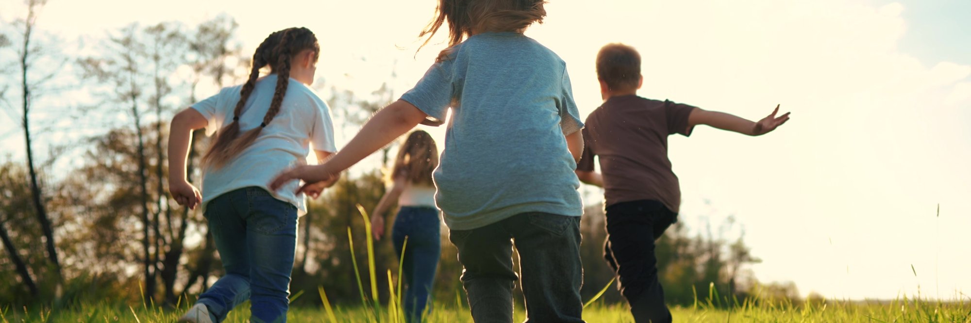 image of children running in a grass