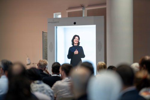 Carlotta Clivio, Quantum Lead, delivers a presentation on quantum technologies via a life-sized holographic display during ITCILO Innovation Day 2026, as audience members watch.