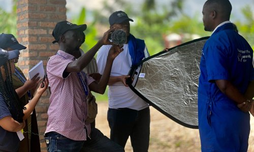 participants interviewing a farmer in Rwanda