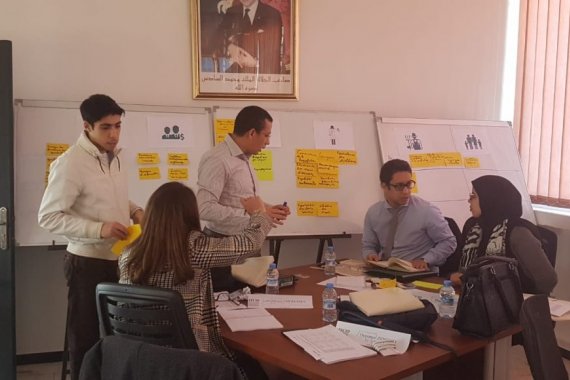 Group of staff around table in office 