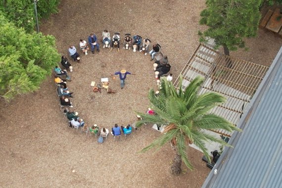 drone image of people standing in a circle