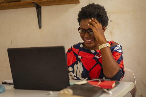 woman laughing and smiling at laptop