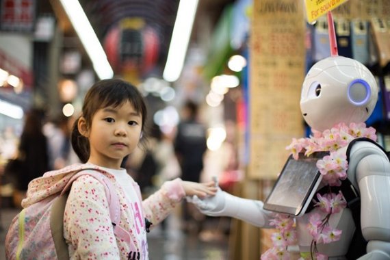 young girl touching a robot