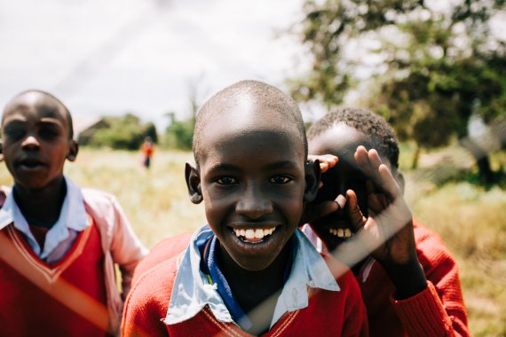 three boys smiling during daytime