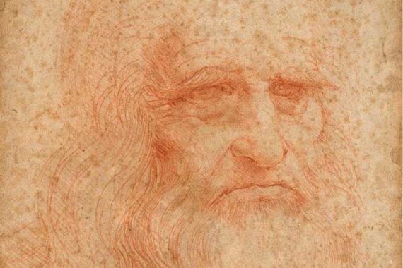 A detailed red chalk drawing of an elderly, bearded man's face, attributed to Leonardo da Vinci, featuring expressive eyes, a furrowed brow and flowing hair on aged parchment.