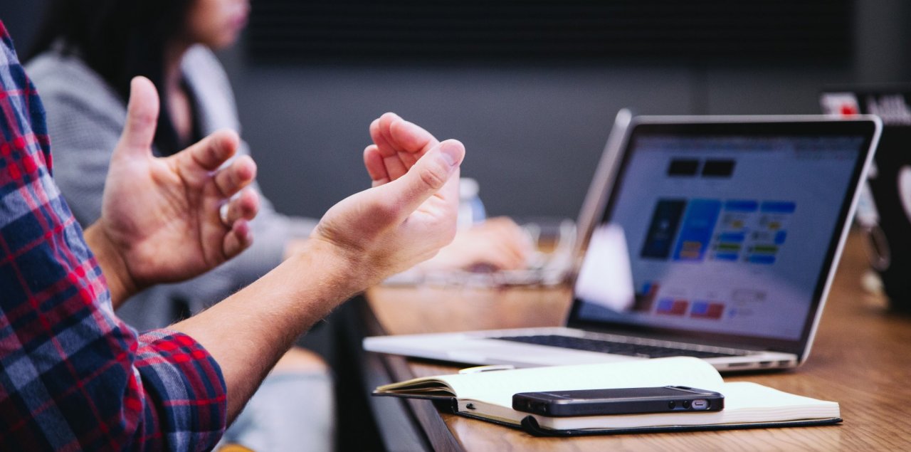 hands in front of a computer